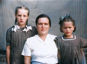 Tanya and her daughters Raisa (left) and Julya, dressed in clothes made by their mum.